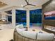 Gathering room with fireplace, TV, and access to the pool area at 9224 Starry Night Ave, Sarasota, FL 34241