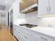 Modern kitchen with white cabinets, gas cooktop and quartz countertops at 9224 Starry Night Ave, Sarasota, FL 34241