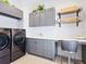 Spacious laundry room with washer, dryer, and built-in cabinets at 9224 Starry Night Ave, Sarasota, FL 34241