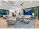 Open living area with sectional sofa and large screen TV at 9224 Starry Night Ave, Sarasota, FL 34241