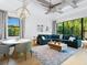 Bright living room features a sectional sofa, dining area, and large windows at 9224 Starry Night Ave, Sarasota, FL 34241