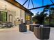 Outdoor kitchen and fire pit area with comfortable seating at 9224 Starry Night Ave, Sarasota, FL 34241