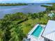 Aerial view showcasing the home's pool and waterfront location at 931 Bayshore Rd, Nokomis, FL 34275
