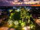 Night view of waterfront property with landscape lighting at 931 Bayshore Rd, Nokomis, FL 34275