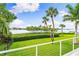 Serene backyard oasis with lush landscaping and waterfront views at 931 Bayshore Rd, Nokomis, FL 34275