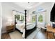 Bright bedroom with a four-poster bed and large windows at 931 Bayshore Rd, Nokomis, FL 34275