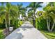 Long driveway leading to home with palm trees at 931 Bayshore Rd, Nokomis, FL 34275