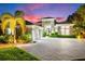 Evening view of home with landscape lighting at 931 Bayshore Rd, Nokomis, FL 34275