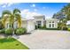 Luxury home with stone accents, metal roof, and paver driveway at 931 Bayshore Rd, Nokomis, FL 34275