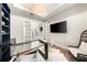 Bright home office features glass desk and French doors at 931 Bayshore Rd, Nokomis, FL 34275