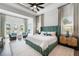 Green upholstered bed in spacious main bedroom with sitting area at 931 Bayshore Rd, Nokomis, FL 34275