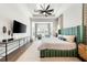 Main bedroom with large TV and sitting area by windows at 931 Bayshore Rd, Nokomis, FL 34275