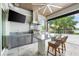 Outdoor kitchen with stainless steel appliances and granite countertops at 931 Bayshore Rd, Nokomis, FL 34275