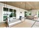 Relaxing patio with a swinging daybed and water views at 931 Bayshore Rd, Nokomis, FL 34275