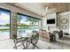 Outdoor patio with fireplace, pool view, and dining area at 931 Bayshore Rd, Nokomis, FL 34275