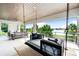 Covered patio with swinging daybed and water views at 931 Bayshore Rd, Nokomis, FL 34275