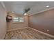 Bright bedroom with wood-look floors and ceiling fan at 9428 Concord Cir, Bradenton, FL 34210