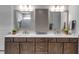 Double vanity bathroom with quartz countertops and dark wood cabinets at 10739 Spring Tide Way, Parrish, FL 34219