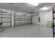 Two-car garage with epoxy flooring and ample storage at 10739 Spring Tide Way, Parrish, FL 34219