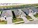 Three homes with gray roofs and paver driveways, near a canal at 11380 Burgundy Dr, Venice, FL 34293