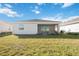 Backyard view featuring lush lawn and a covered screened patio, perfect for outdoor relaxation at 11380 Burgundy Dr, Venice, FL 34293