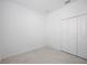 A bright, empty bedroom featuring a closet and tile flooring is ready for personalized touches at 11380 Burgundy Dr, Venice, FL 34293