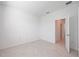 A clean and well lit bedroom with neutral walls and flooring, door open revealing a corridor at 11380 Burgundy Dr, Venice, FL 34293
