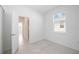 Bright bedroom featuring neutral walls, window with blinds, and tiled floors at 11380 Burgundy Dr, Venice, FL 34293