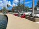 Red adirondack chairs along a wooden community boardwalk, overlooking the lake in a planned community at 11380 Burgundy Dr, Venice, FL 34293