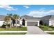 One-story home with gray roof, paver driveway, and landscaping at 11380 Burgundy Dr, Venice, FL 34293