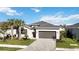 Charming one-story home with a two-car garage, brick paver driveway and manicured lawn at 11380 Burgundy Dr, Venice, FL 34293