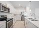 Modern kitchen featuring stainless steel appliances, white cabinets, and stylish countertops at 11380 Burgundy Dr, Venice, FL 34293
