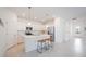 A well-lit kitchen boasts an island with counter seating and stainless-steel appliances at 11380 Burgundy Dr, Venice, FL 34293