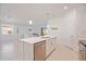 Bright open-concept kitchen with a central island and stainless steel appliances, flowing into the living area at 11380 Burgundy Dr, Venice, FL 34293
