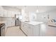 Open-concept kitchen featuring stainless steel appliances, a center island, and seamless access to the living area at 11380 Burgundy Dr, Venice, FL 34293