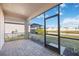 Covered patio overlooking the yard and pond, ideal for relaxing outdoors at 11380 Burgundy Dr, Venice, FL 34293