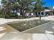 Community splash pad with in-ground water jets surrounded by a concrete deck and walkway at 11380 Burgundy Dr, Venice, FL 34293