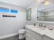 Clean bathroom with a single vanity, toilet, and shower at 120 Lookout Point Dr, Osprey, FL 34229