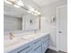 Modern bathroom with dual vanity, quartz countertops, and brushed gold fixtures at 120 Lookout Point Dr, Osprey, FL 34229