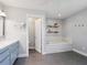Spa-like bathroom featuring a soaking tub, dual vanity, and walk-in shower at 120 Lookout Point Dr, Osprey, FL 34229