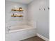 Elegant bathroom with soaking tub, tile flooring, and modern fixtures at 120 Lookout Point Dr, Osprey, FL 34229