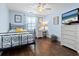 Cozy bedroom with a full-size bed, wood flooring, and a dresser at 120 Lookout Point Dr, Osprey, FL 34229