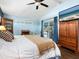 Main bedroom with king bed, wood floors, and sliding glass doors at 120 Lookout Point Dr, Osprey, FL 34229