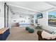 Versatile bonus room with a day bed, comfy seating, and a large TV at 120 Lookout Point Dr, Osprey, FL 34229