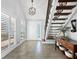 Bright entryway with tile floors, staircase, and chandelier at 120 Lookout Point Dr, Osprey, FL 34229