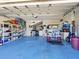 Spacious garage with storage shelving and golf cart at 120 Lookout Point Dr, Osprey, FL 34229
