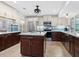 Modern kitchen featuring island, stainless steel appliances, and white and dark wood cabinetry at 120 Lookout Point Dr, Osprey, FL 34229