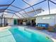 Relaxing pool area with a screened enclosure and patio furniture at 120 Lookout Point Dr, Osprey, FL 34229