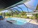 Screened pool and patio area with fire pit at 120 Lookout Point Dr, Osprey, FL 34229