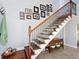 Elegant staircase with wooden steps and an iron railing at 120 Lookout Point Dr, Osprey, FL 34229